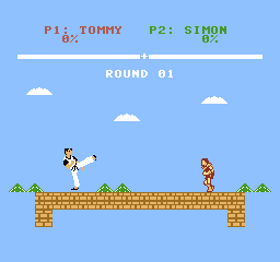 Tommy holds a high extended kick on the left. Simon stands on the right.